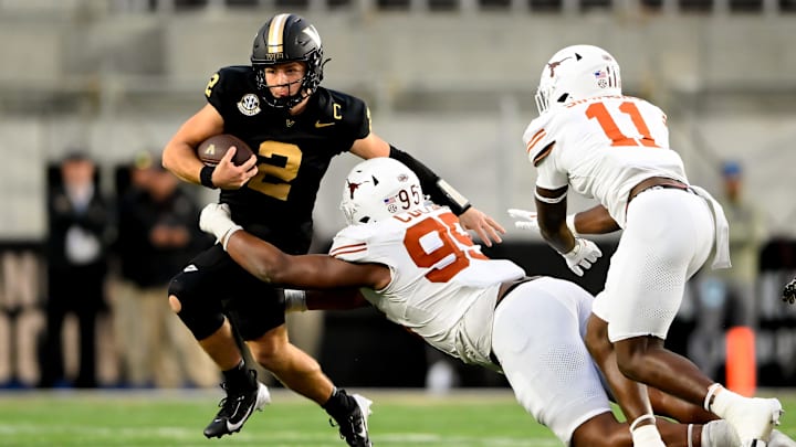 Oct 26, 2024; Nashville, Tennessee, USA;  Texas Longhorns defensive lineman Alfred Collins (95) tackles Vanderbilt Commodores quarterback Diego Pavia (2) for a loss during the second half at FirstBank Stadium. Mandatory Credit: Steve Roberts-Imagn Images