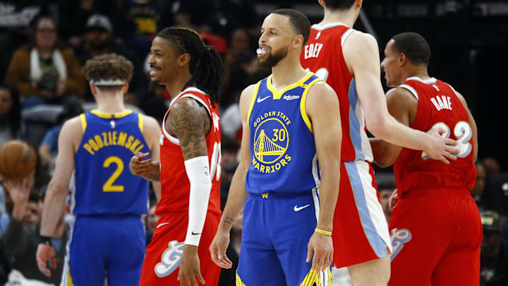 Memphis Grizzlies guard Morant and Golden State Warriors guard Curry react during the third quarter at FedExForum. 