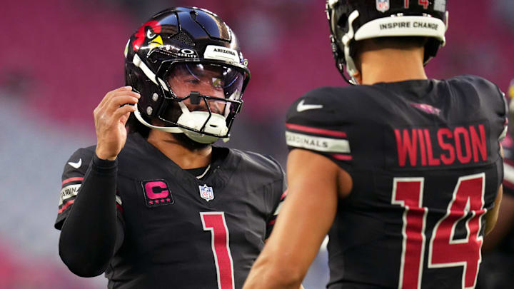 Arizona Cardinals quarterback Kyler Murray (1) high-fives teammate Michael Wilson (14) before their game against the Los Angeles Chargers at State Farm Stadium in Glendale on Oct. 21, 2024. Arizona Cardinals quarterback Kyler Murray (1) high-fives teammate Michael Wilson (14) before their game against the Los Angeles Chargers at State Farm Stadium in Glendale on Oct. 21, 2024.
