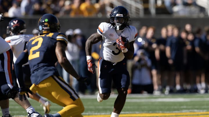 Nov 1, 2025; Berkeley, California, USA; Virginia Cavaliers running back J'Mari Taylor (3) runs the ball against defensive back Dru Polidore Jr. (2) during the first quarter at California Memorial Stadium. Mandatory Credit: D. Ross Cameron-Imagn Images