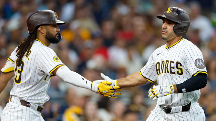 Aug 2, 2025; San Diego, California, USA; San Diego Padres left fielder Ramon Laureano (5) celebrates with right fielder Fernando Tatis Jr. (23) after scoring a run during the second inning against the St. Louis Cardinals at Petco Park. Mandatory Credit: David Frerker-Imagn Images