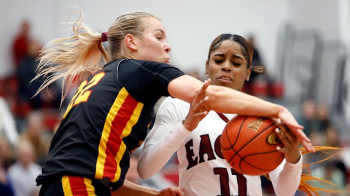Oakland Catholic senior guard/forward London Creach attempts to shield the ball from Noth Catholic's Sarah Loughry during a WPIAL Class 4A semifinal Monday night at Fox Chapel High School. Creach scored 14 points in a 57-29 win for the Eagles.