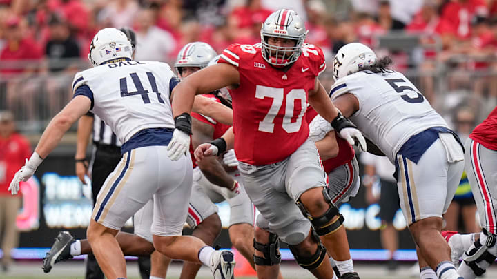 Aug 31, 2024; Columbus, OH, USA; Ohio State Buckeyes offensive lineman Josh Fryar (70) leads the block during the NCAA football game against the Akron Zips at Ohio Stadium. Ohio State won 52-6.