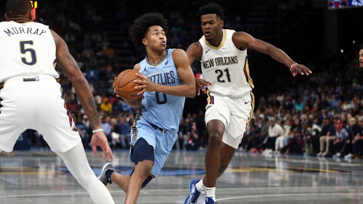 Nov 29, 2024; Memphis, Tennessee, USA; Memphis Grizzlies forward Jaylen Wells (0) drives to the basket as New Orleans Pelicans center Yves Missi (21) defends during the second quarter at FedExForum. Mandatory Credit: Petre Thomas-Imagn Images