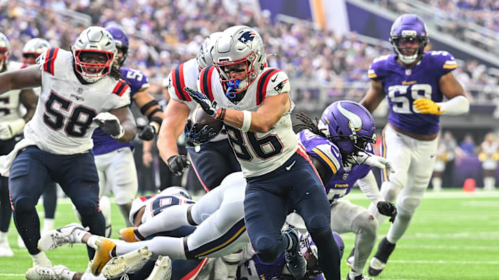 Aug 16, 2025; Minneapolis, Minnesota, USA; New England Patriots wide receiver Efton Chism III (86) scores a touchdown as center Jared Wilson (58) looks on during the second quarter at U.S. Bank Stadium. Mandatory Credit: Jeffrey Becker-Imagn Images