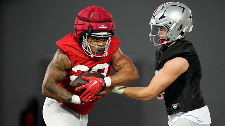 Ohio State Buckeyes quarterback Lincoln Kienholz (3) hands off to running back TC Caffey (28) during spring football practice at the Woody Hayes Athletic Center in Columbus on March 19, 2025.