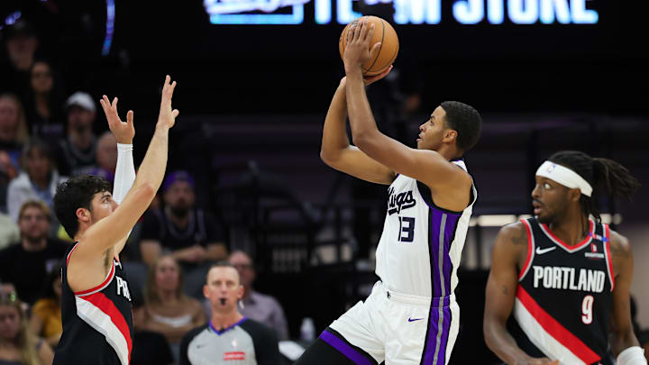 Oct 13, 2024; Sacramento, California, USA;  Sacramento Kings forward Keegan Murray (13) shoots the ball against Portland Trail Blazers forward Deni Avdija (8) during the first quarter at Golden 1 Center. Mandatory Credit: Sergio Estrada-Imagn Images