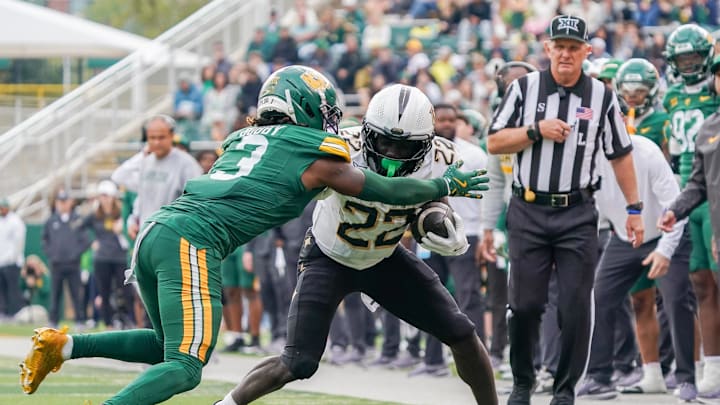 Nov 1, 2025; Waco, Texas, USA; UCF Knights running back Myles Montgomery (22) carries the ball as Baylor Bears safety Devyn Bobby (3) defends during the second half at McLane Stadium. Mandatory Credit: Raymond Carlin III-Imagn Images