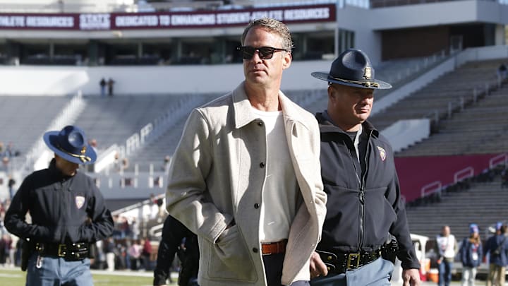 Nov 28, 2025; Starkville, Mississippi, USA; Mississippi Rebels head coach Lane Kiffin walks on field before the game against the Mississippi State Bulldogs at Davis Wade Stadium at Scott Field. Mandatory Credit: Petre Thomas-Imagn Images Nov 28, 2025; Starkville, Mississippi, USA; Mississippi Rebels head coach Lane Kiffin walks on field before the game against the Mississippi State Bulldogs at Davis Wade Stadium at Scott Field. Mandatory Credit: Petre Thomas-Imagn Images