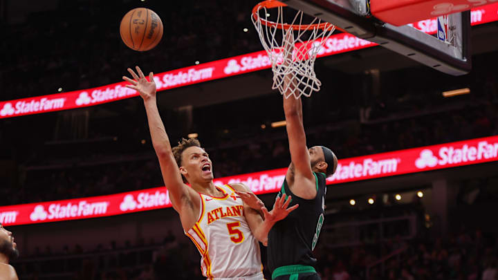 Nov 4, 2024; Atlanta, Georgia, USA; Atlanta Hawks guard Dyson Daniels (5) shoots past Boston Celtics guard Derrick White (9) in the third quarter at State Farm Arena. Mandatory Credit: Brett Davis-Imagn Images
