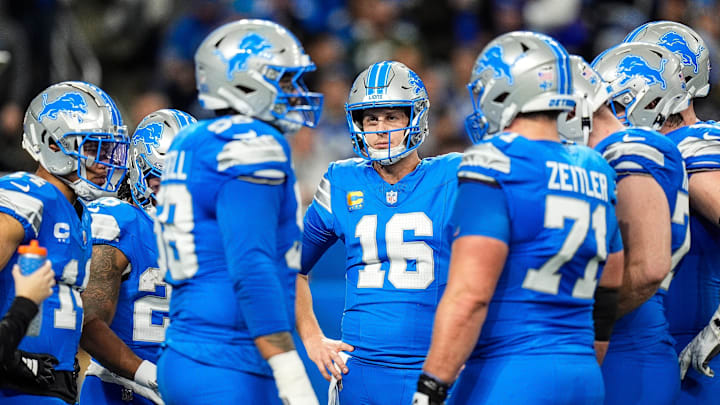 Detroit Lions quarterback Jared Goff (16), center, talks to teammates.
