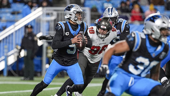 Dec 1, 2024; Charlotte, North Carolina, USA; Carolina Panthers quarterback Bryce Young (9) readies to throw under pressure from Tampa Bay Buccaneers linebacker Anthony Nelson (98) during the second half at Bank of America Stadium. Mandatory Credit: Jim Dedmon-Imagn Images