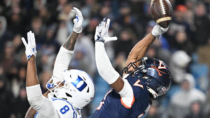 Dec 6, 2025; Charlotte, NC, USA; Virginia Cavaliers wide receiver Trell Harris (11) attempts to catch the ball in the end zone as Duke Blue Devils cornerback Landan Callahan (21) and safety Dashawn Stone (8) defend in the fourth quarter during the  ACC Championship game at Bank of America Stadium. Mandatory Credit: Bob Donnan-Imagn Images