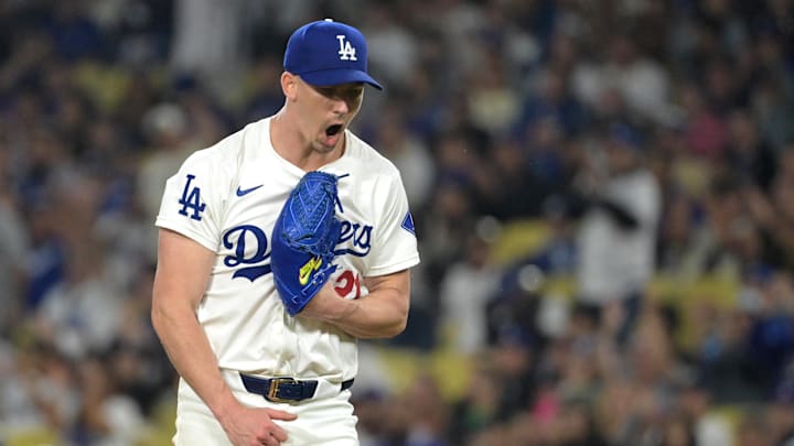 Sep 26, 2024; Los Angeles, California, USA;  Los Angeles Dodgers starting pitcher Walker Buehler (21) reacts after a double play to end the fourth inning against the San Diego Padres at Dodger Stadium. Mandatory Credit: Jayne Kamin-Oncea-Imagn Images