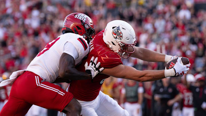 Louisville tight end Mark Redman, a former Husky, reaches the ball into the end zone for a touchdown Jacksonville State. Louisville tight end Mark Redman, a former Husky, reaches the ball into the end zone for a touchdown Jacksonville State.