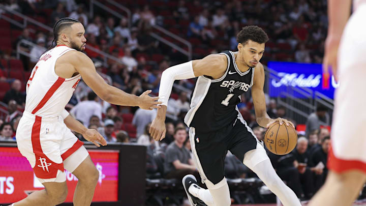 San Antonio Spurs center Victor Wembanyama (1) drives with the ball as Houston Rockets forward Dillon Brooks (9) defends during the first quarter at Toyota Center. Mandatory Credit: Troy Taormina-Imagn Images San Antonio Spurs center Victor Wembanyama (1) drives with the ball as Houston Rockets forward Dillon Brooks (9) defends during the first quarter at Toyota Center. Mandatory Credit: Troy Taormina-Imagn Images