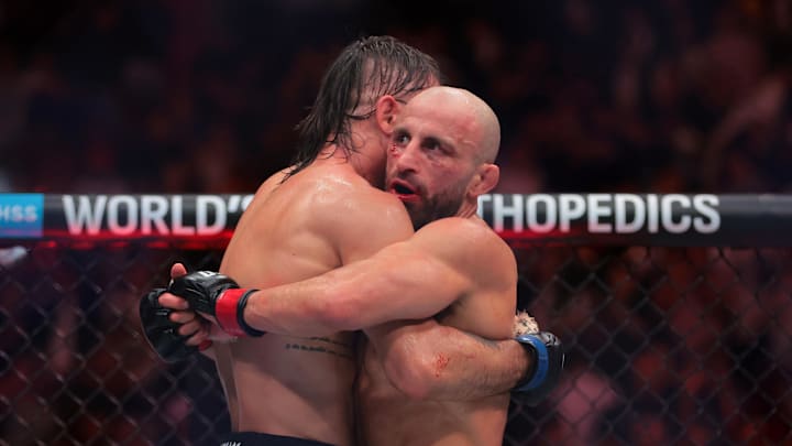 Apr 12, 2025; Miami, Florida, UNITED STATES; Alexander Volkanovski (red gloves) shake hands hugs Diego Lopes (blue gloves) during UFC 314 at Kaseya Center. Mandatory Credit: Sam Navarro-Imagn Images