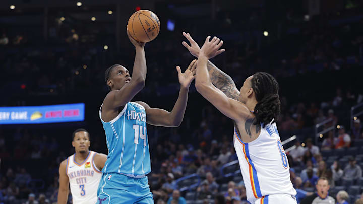 Oct 9, 2025; Oklahoma City, Oklahoma, USA; Charlotte Hornets forward Moussa Diabaté (14) shoots as Oklahoma City Thunder forward Jaylin Williams (6) defends during the second half of a game between the Charlotte Hornets and the Oklahoma City Thunder at Paycom Center. Mandatory Credit: Alonzo Adams-Imagn Images