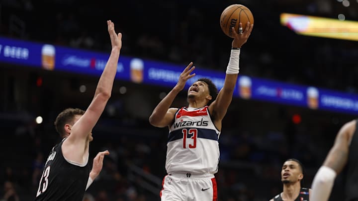 Feb 26, 2025; Washington, District of Columbia, USA; Washington Wizards guard Jordan Poole (13) shoots the ball over Portland Trail Blazers center Donovan Clingan (23) in the second half at Capital One Arena. Mandatory Credit: Geoff Burke-Imagn Images