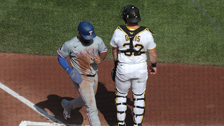 Jun 21, 2025; Pittsburgh, Pennsylvania, USA; Texas Rangers first baseman Ezequiel Duran (20) crosses home plate to score a run against the Pittsburgh Pirates during the third inning at PNC Park. Mandatory Credit: Charles LeClaire-Imagn Images