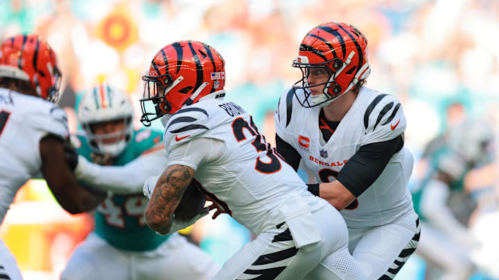 Dec 21, 2025; Miami Gardens, Florida, USA; Cincinnati Bengals quarterback Joe Burrow (9) hands off the ball to Cincinnati Bengals running back Chase Brown (30) during the first quarter against the Miami Dolphins at Hard Rock Stadium. Mandatory Credit: Sam Navarro-Imagn Images