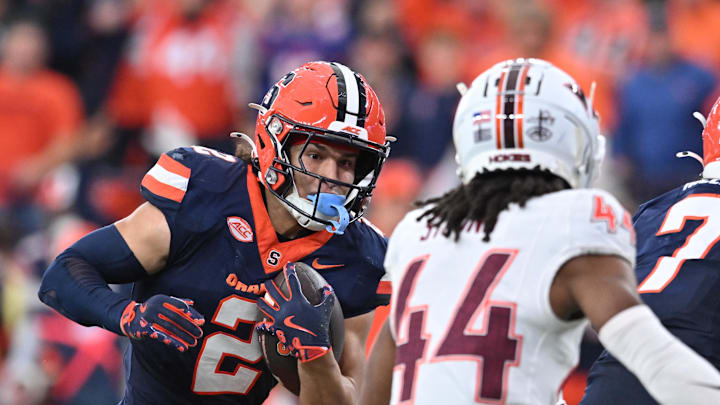 Nov 2, 2024; Syracuse, New York, USA; Syracuse Orange wide receiver Trebor Pena (2) tries to avoid a tackle by Virginia Tech Hokies cornerback Dorian Strong (44) in the third quarter at JMA Wireless Dome. Mandatory Credit: Mark Konezny-Imagn Images