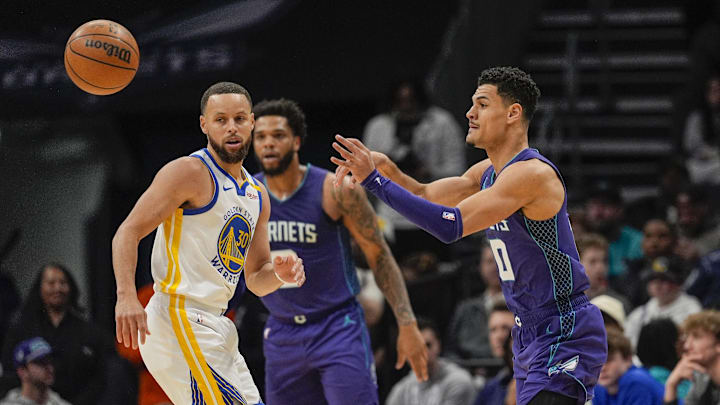 Mar 3, 2025; Charlotte, North Carolina, USA; Charlotte Hornets forward Miles Bridges (0) passes the ball in front of Golden State Warriors guard Stephen Curry (30) during the second quarter at Spectrum Center. Mandatory Credit: Jim Dedmon-Imagn Images Mar 3, 2025; Charlotte, North Carolina, USA; Charlotte Hornets forward Miles Bridges (0) passes the ball in front of Golden State Warriors guard Stephen Curry (30) during the second quarter at Spectrum Center. Mandatory Credit: Jim Dedmon-Imagn Images