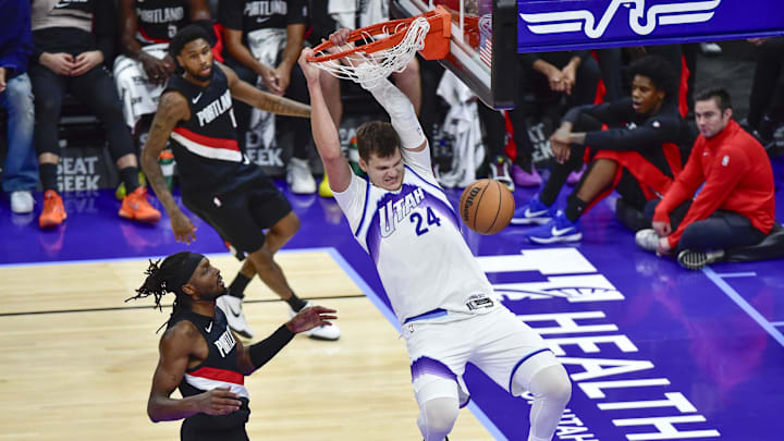 Oct 16, 2025; Salt Lake City, Utah, USA; Utah Jazz center Walker Kessler (24) makes a slam dunk during the second half over Portland Trail Blazers guard Damian Lillard (0) at Delta Center. Mandatory Credit: Peter Creveling-Imagn Images
