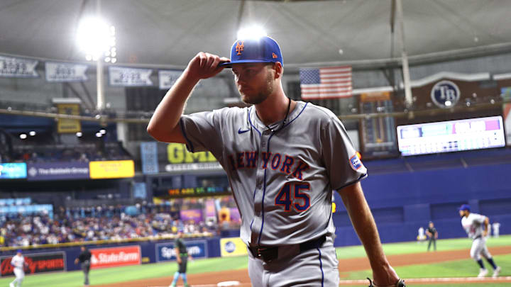 May 4, 2024; St. Petersburg, Florida, USA; New York Mets starting pitcher Christian Scott (45) tips his hat as he is taken out of the game against the Tampa Bay Rays during the seventh inning  at Tropicana Field. Mandatory Credit: Kim Klement Neitzel-Imagn Images