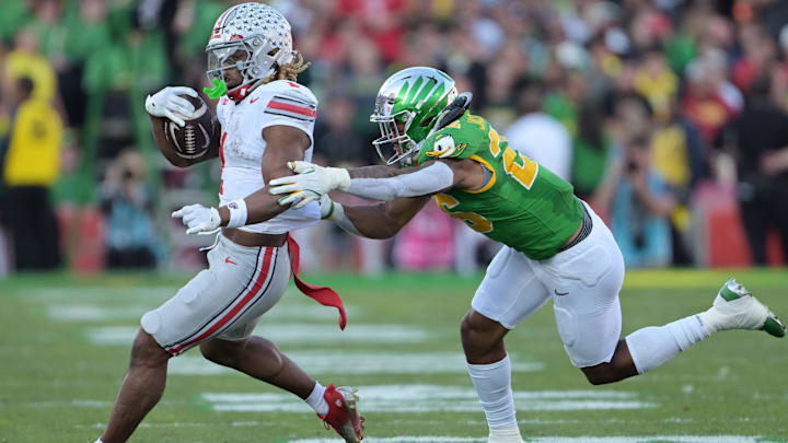 Jan 1, 2025; Pasadena, CA, USA; Ohio State Buckeyes running back Quinshon Judkins (1) runs against Oregon Ducks linebacker Devon Jackson (26) in the second quarter in the 2025 Rose Bowl college football quarterfinal game at Rose Bowl Stadium. Mandatory Credit: Jayne Kamin-Oncea-Imagn Images