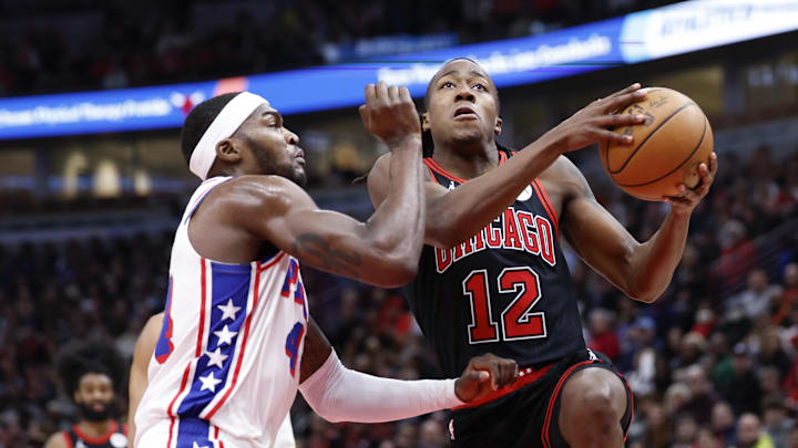 Dec 30, 2023; Chicago, Illinois, USA; Chicago Bulls guard Ayo Dosunmu (12) goes to the basket against Philadelphia 76ers forward Paul Reed (44) during the first half at United Center. Mandatory Credit: Kamil Krzaczynski-Imagn Images