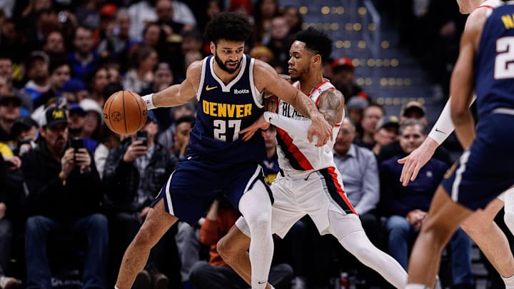 Feb 12, 2025; Denver, Colorado, USA; Denver Nuggets guard Jamal Murray (27) controls the ball as Portland Trail Blazers guard Anfernee Simons (1) guards in the second quarter at Ball Arena. Mandatory Credit: Isaiah J. Downing-Imagn Images
