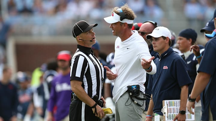 Oct 26, 2024; Oxford, Mississippi, USA; Mississippi Rebels head coach Lane Kiffin talks with an official after a flag during the second half against the Oklahoma Sooners at Vaught-Hemingway Stadium. Mandatory Credit: Petre Thomas-Imagn Images Oct 26, 2024; Oxford, Mississippi, USA; Mississippi Rebels head coach Lane Kiffin talks with an official after a flag during the second half against the Oklahoma Sooners at Vaught-Hemingway Stadium. Mandatory Credit: Petre Thomas-Imagn Images