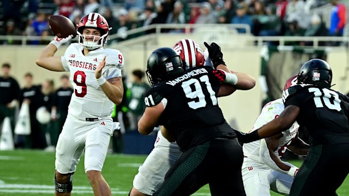Nov 2, 2024; East Lansing, Michigan, USA;  Indiana Hoosiers quarterback Kurtis Rourke (9) looks for a receiver during the fourth quarter against the Michigan State Spartans at Spartan Stadium. Mandatory Credit: Dale Young-Imagn Images