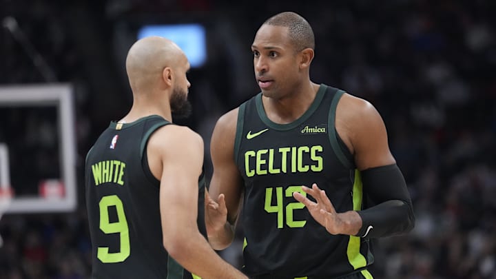 Jan 15, 2025; Toronto, Ontario, CAN; Boston Celtics center Al Horford (42) talks to guard Derrick White (9) during the first half against the Toronto Raptors at Scotiabank Arena. Mandatory Credit: John E. Sokolowski-Imagn Images