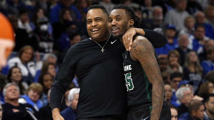 Feb 4, 2023; Memphis, Tennessee, USA; Tulane Green Wave head coach Ron Hunter (left) hugs guard Jaylen Forbes (25) during a timeout during the second half against the Memphis Tigers at FedExForum.