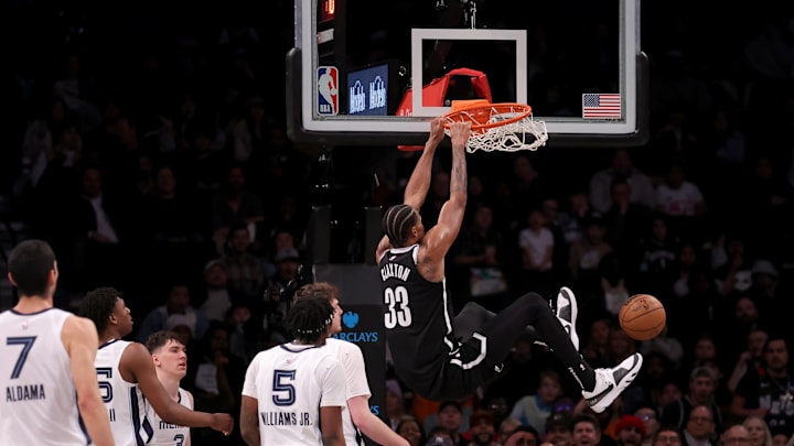 Mar 4, 2024; Brooklyn, New York, USA; Brooklyn Nets center Nic Claxton (33) hangs on the rim after a dunk. 