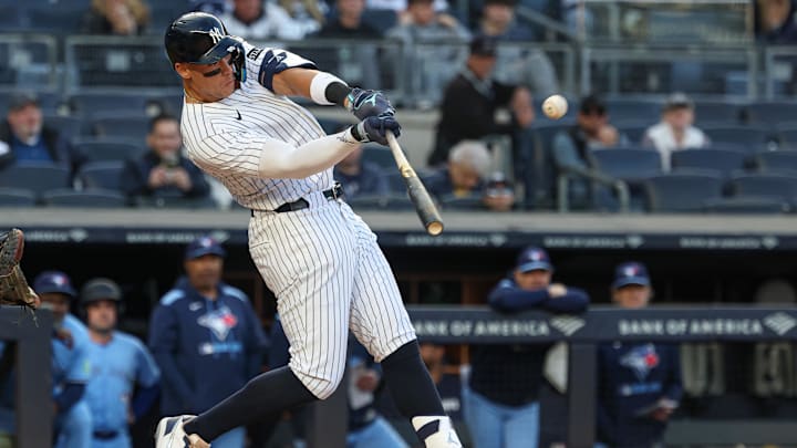 Apr 27, 2025; Bronx, New York, USA;  New York Yankees right fielder Aaron Judge (99) hits a solo home run during the sixth inning against the Toronto Blue Jays at Yankee Stadium.