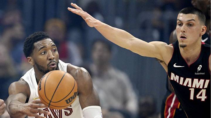 Mar 25, 2026; Cleveland, Ohio, USA; Cleveland Cavaliers guard Donovan Mitchell (45) passes the ball beside Miami Heat guard Tyler Herro (14) in the first quarter at Rocket Arena. Mandatory Credit: David Richard-Imagn Images