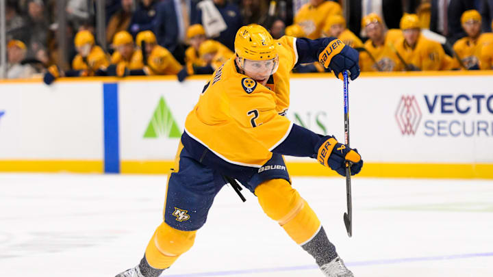 Jan 21, 2025; Nashville, Tennessee, USA;  Nashville Predators defenseman Luke Schenn (2) takes a shot on goal against the San Jose Sharks during the first period at Bridgestone Arena. Mandatory Credit: Steve Roberts-Imagn Images