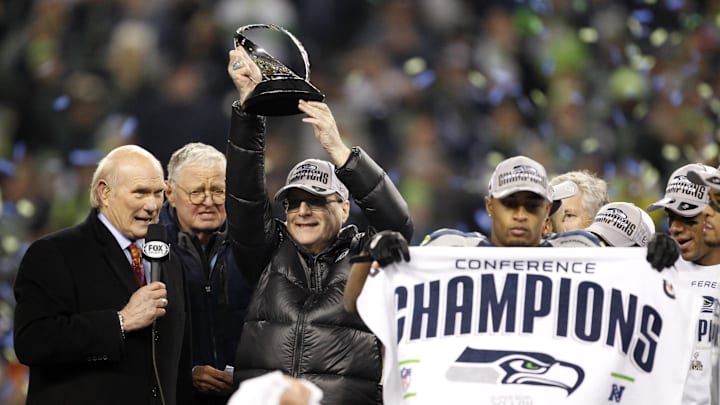Jan 19, 2014; Seattle, WA, USA; Seattle Seahawks owner Paul Allen hoists the George Halas Trophy after the 2013 NFC Championship football game against the San Francisco 49ers at CenturyLink Field. Mandatory Credit: Joe Nicholson-Imagn Images
