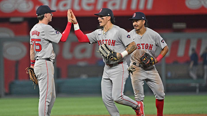 Aug 5, 2024; Kansas City, Missouri, USA;  Boston Red Sox players Boston Red Sox left fielder Jarren Duran (center), second baseman Nick Sogard (left) and shortstop David Hamilton (right) celebrate after beating the Kansas City Royals at Kauffman Stadium. Mandatory Credit: Peter Aiken-Imagn Images