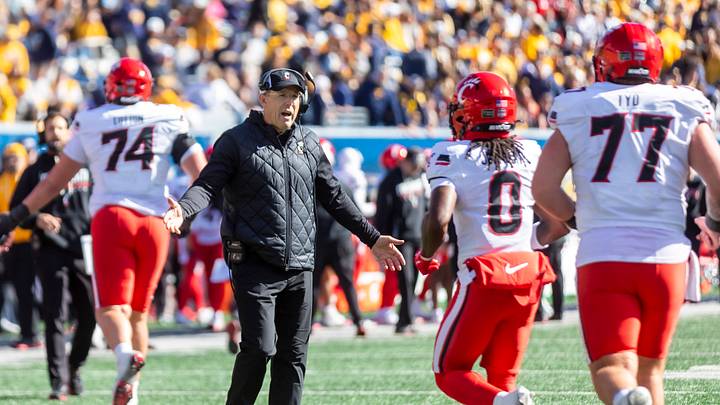 Oct 17, 2026; Morgantown, West Virginia, USA; Cincinnati Bearcats head coach Scott Satterfield celebrates with players during the third quarter against the West Virginia Mountaineers at Milan Puskar Stadium. Mandatory Credit: Ben Queen-Imagn Images Oct 17, 2026; Morgantown, West Virginia, USA; Cincinnati Bearcats head coach Scott Satterfield celebrates with players during the third quarter against the West Virginia Mountaineers at Milan Puskar Stadium. Mandatory Credit: Ben Queen-Imagn Images