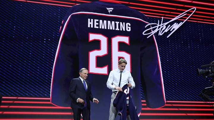 Jun 26, 2026; Buffalo, New York, USA; Oscar Hemming reacts beside NHL commissioner Gary Bettman after being selected with the fourteenth pick in the first round of the 2026 NHL Draft by the Columbus Blue Jackets at KeyBank Center. Mandatory Credit: Timothy T. Ludwig-Imagn Images