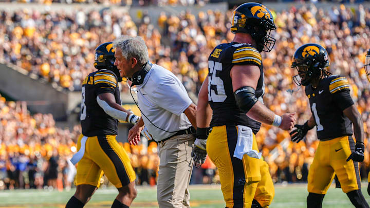 Iowa Hawkeyes head coach Kirk Ferentz high-fives his players as they come off the field against the Indiana Hoosiers Sept. 27, 2025 at Kinnick Stadium in Iowa City, Iowa.