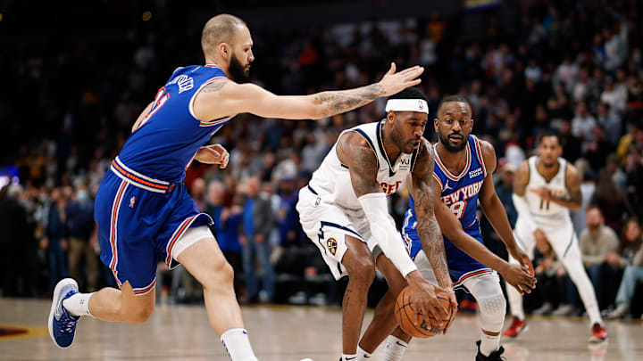 Feb 8, 2022; Denver, Colorado, USA; Denver Nuggets forward Will Barton (5) controls the ball under pressure from New York Knicks guard Evan Fournier (13) and guard Kemba Walker (8) in the first quarter at Ball Arena. Mandatory Credit: Isaiah J. Downing-Imagn Images