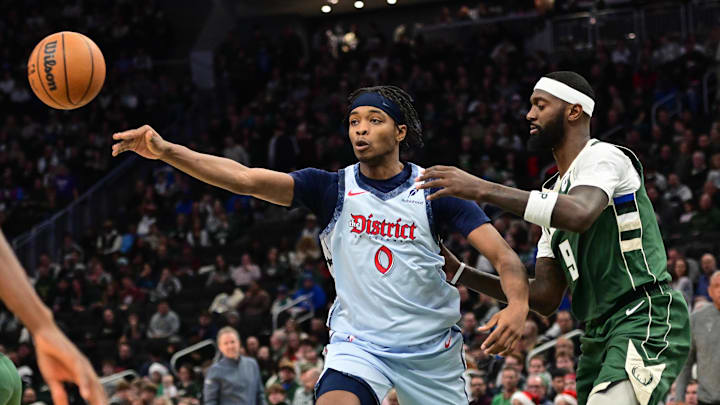 Dec 21, 2024; Milwaukee, Wisconsin, USA; Washington Wizards forward Bilal Coulibaly (0) passes the ball against Milwaukee Bucks forward Bobby Portis (9) in the third quarter at Fiserv Forum. Mandatory Credit: Benny Sieu-Imagn Images
