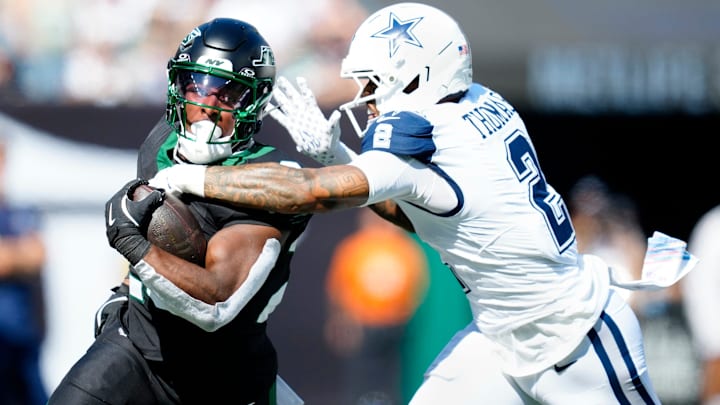 New York Jets running back Breece Hall (20) runs for a first down as Dallas Cowboys safety Juanyeh Thomas (2) attempts to tackle him in the first quarter, Sunday, October 5, 2025. New York Jets running back Breece Hall (20) runs for a first down as Dallas Cowboys safety Juanyeh Thomas (2) attempts to tackle him in the first quarter, Sunday, October 5, 2025.