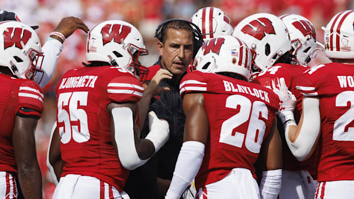 Sep 2, 2023; Madison, Wisconsin, USA;  Wisconsin Badgers head coach Luke Fickell talks in a huddle during the second quarter against the Buffalo Bulls at Camp Randall Stadium. Mandatory Credit: Jeff Hanisch-Imagn Images
