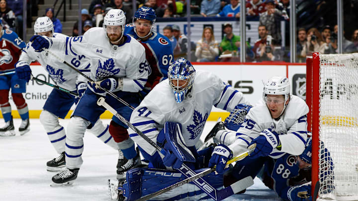 Mar 8, 2025; Denver, Colorado, USA; Toronto Maple Leafs defenseman Brandon Carlo (25) and Colorado Avalanche center Martin Necas (88) battle for the puck behind goaltender Anthony Stolarz (41) as defenseman Oliver Ekman-Larsson (95) and left wing Artturi Lehkonen (62) defend in the second period at Ball Arena. Mandatory Credit: Isaiah J. Downing-Imagn Images
